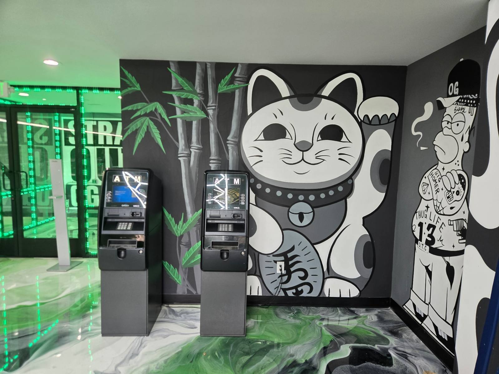 Black and white lucky cat and bamboo mural painted in a storefront lobby