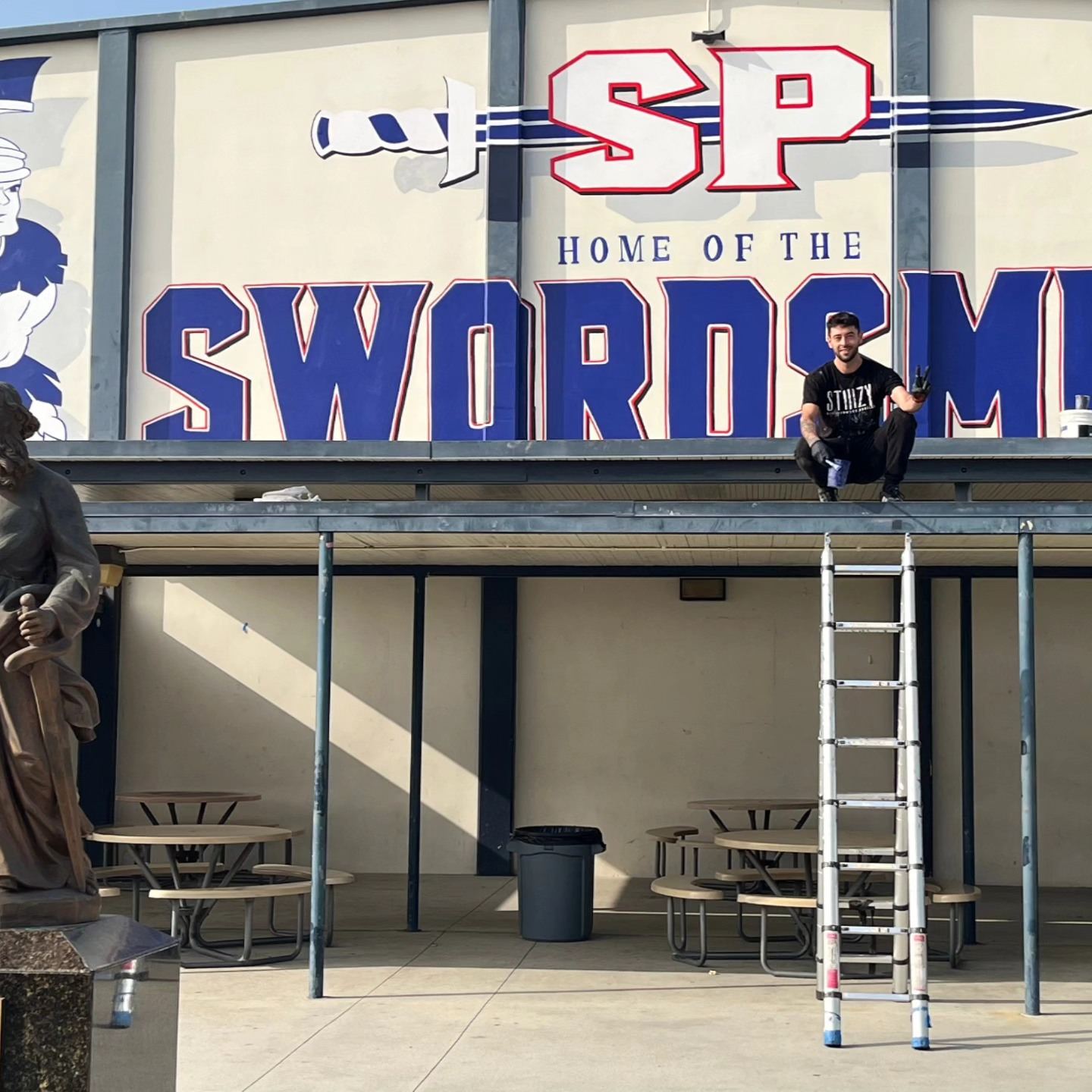 Home of the Swordsmen school facade mural