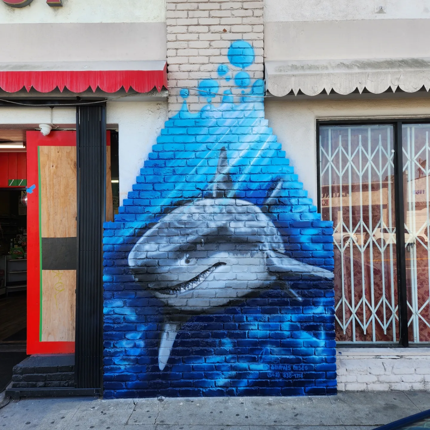 Shark mural on a brick storefront