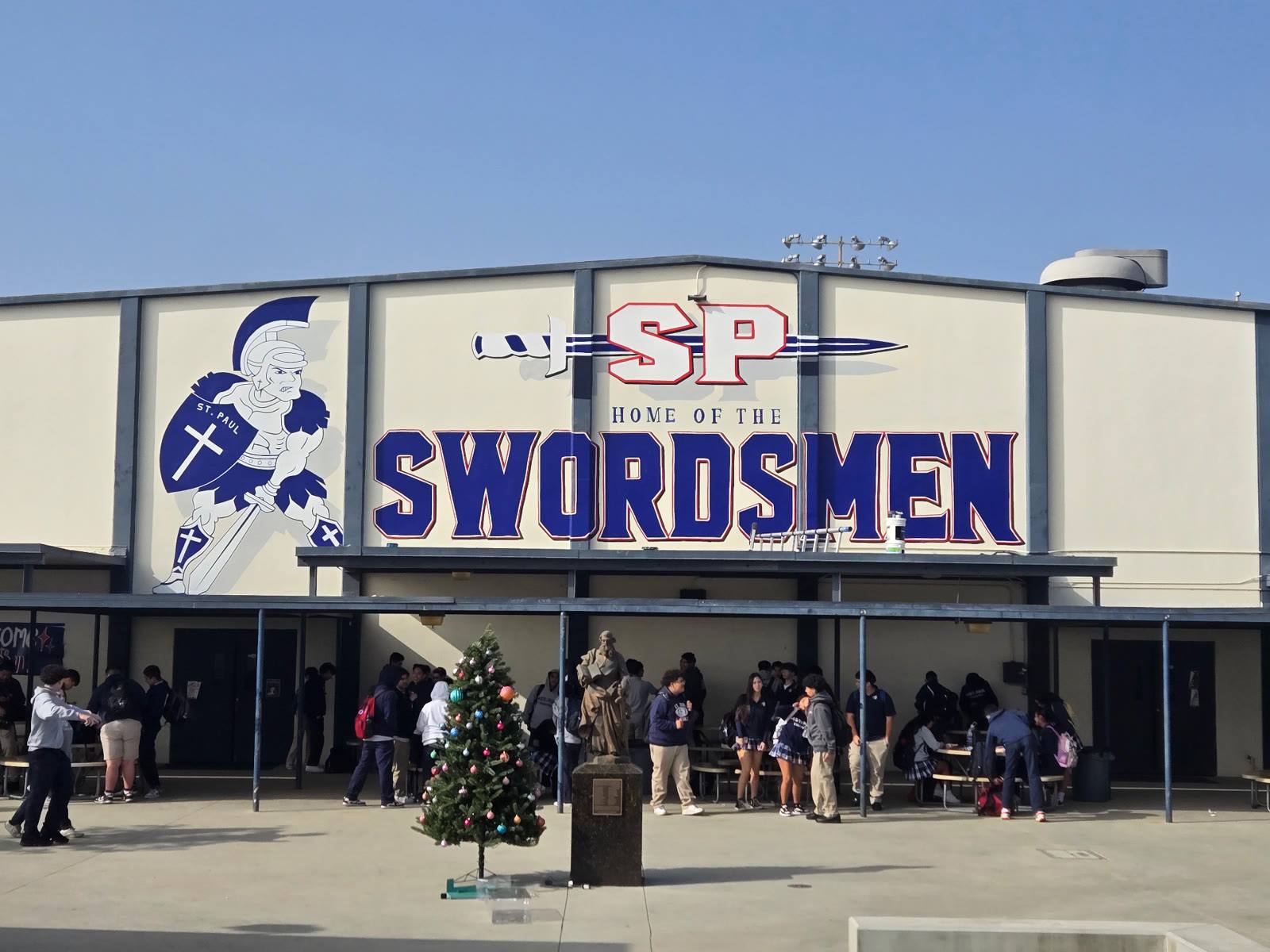 Hand-painted St. Paul Swordsmen mascot and school name on a campus building