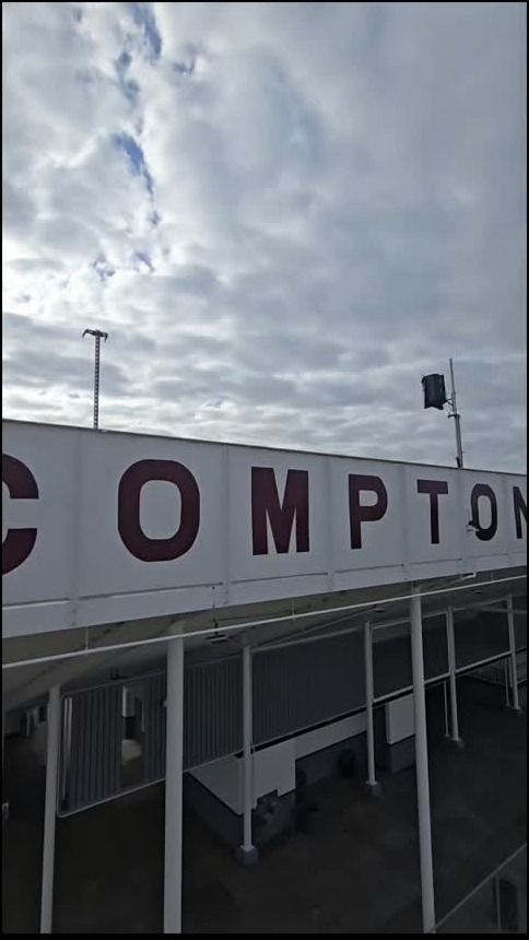 Compton lettering on a stadium facade