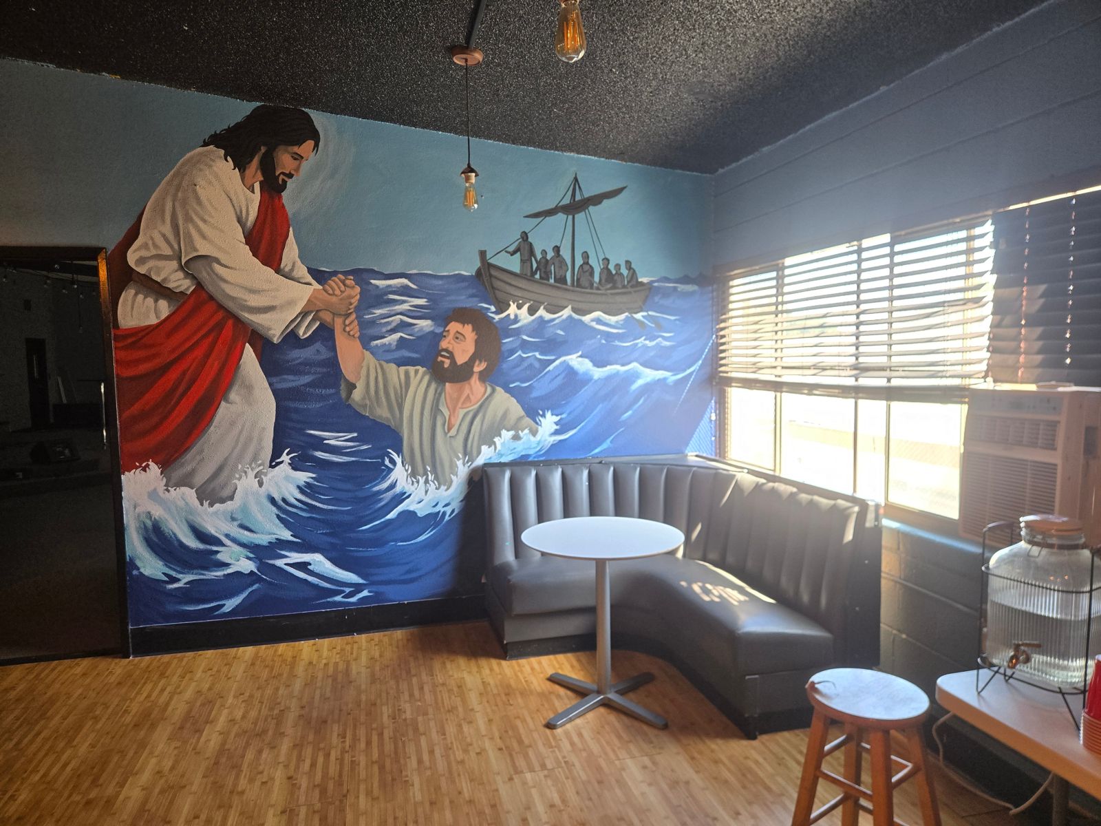 Hand-painted mural of Jesus rescuing Peter from the waves, with the disciples in a boat behind them