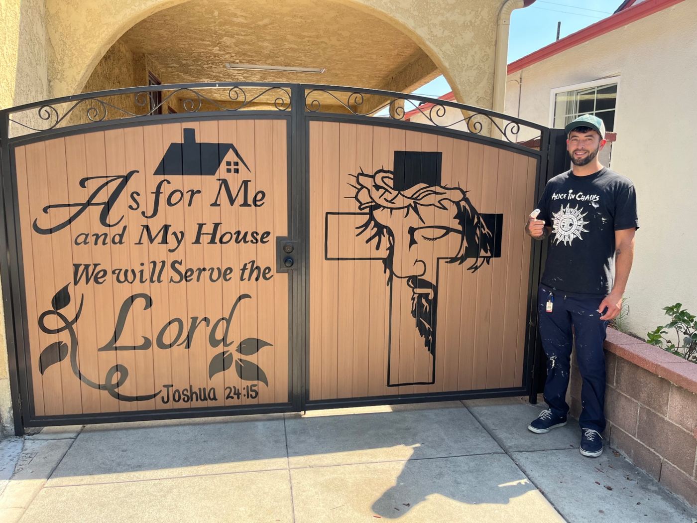 Carlos beside a hand-painted Joshua 24:15 gate