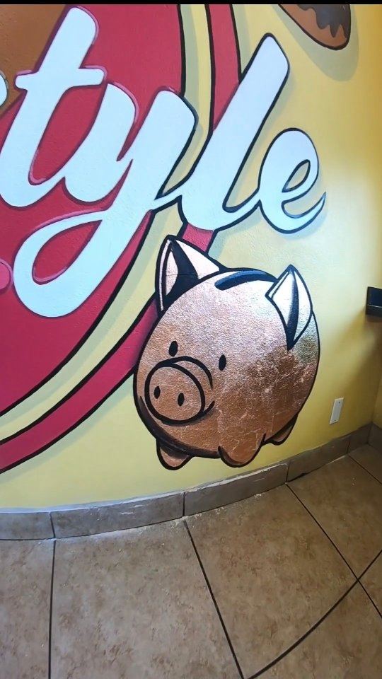 Piggy bank character mural close-up