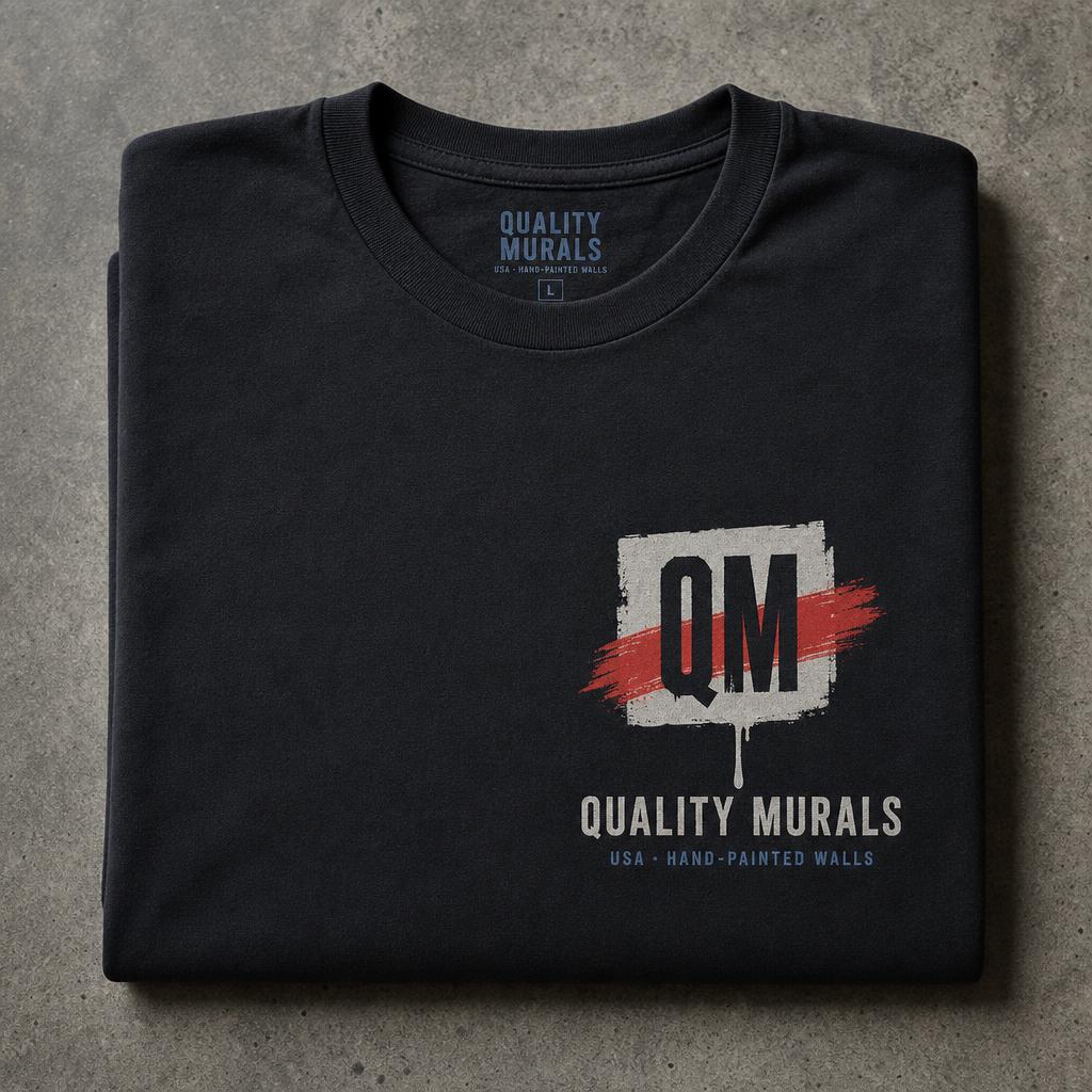 Quality Murals QM badge printed on a black work tee